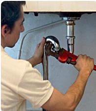 plumber fixing a p trap under a sink